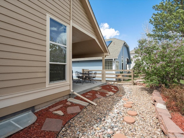 7158 W Belmont Dr, Littleton, CO 80123 - view of side of home with a patio, fence, and outdoor dining area