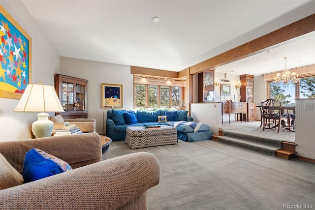 carpeted living room with a notable chandelier and a healthy amount of sunlight