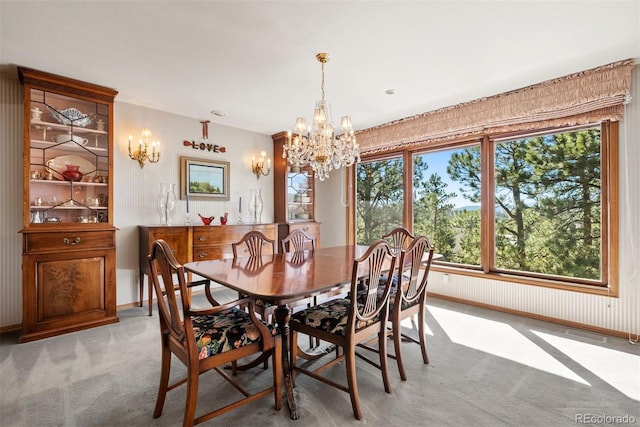 dining area featuring an inviting chandelier, baseboards, visible vents, and light colored carpet