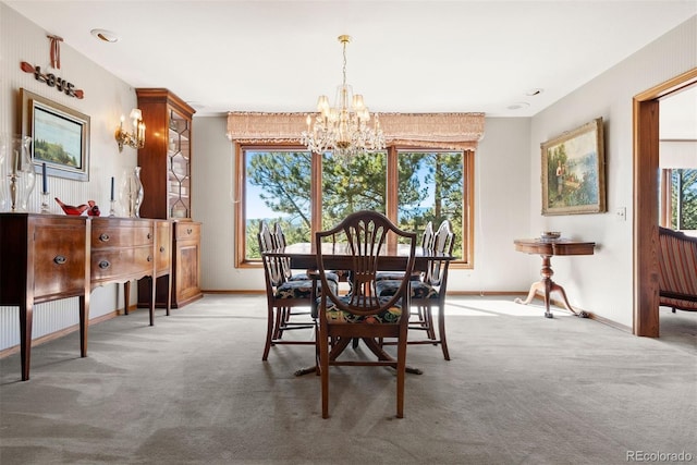 dining area featuring carpet flooring, a notable chandelier, and baseboards