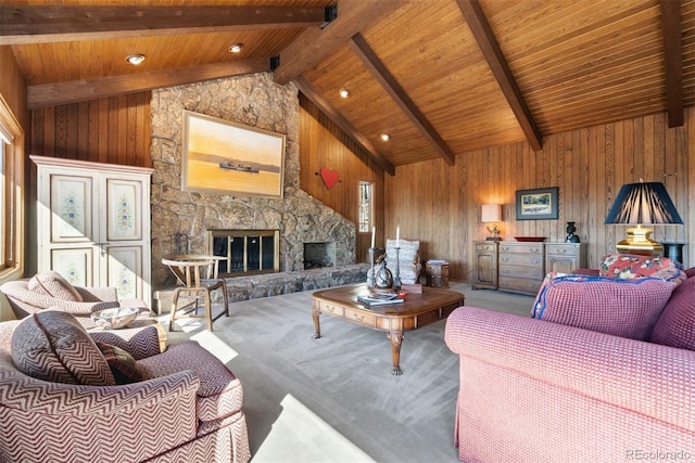 carpeted living area with wood ceiling, wood walls, beamed ceiling, and a stone fireplace