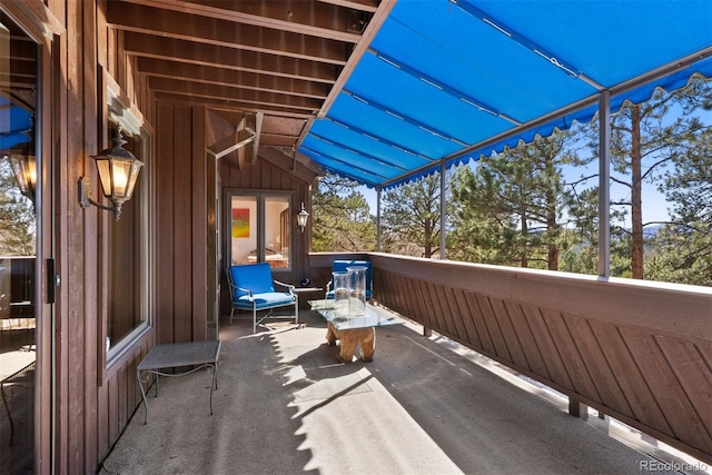 view of patio featuring a balcony