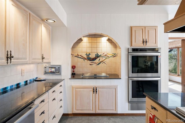 kitchen with double oven, light brown cabinetry, and tasteful backsplash