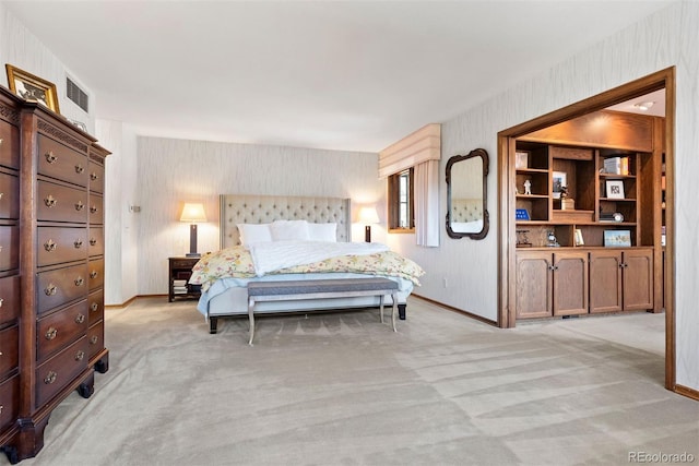 bedroom with light colored carpet, visible vents, and baseboards