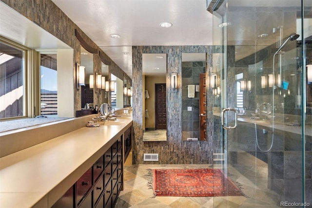 full bath featuring a shower stall, visible vents, and vanity