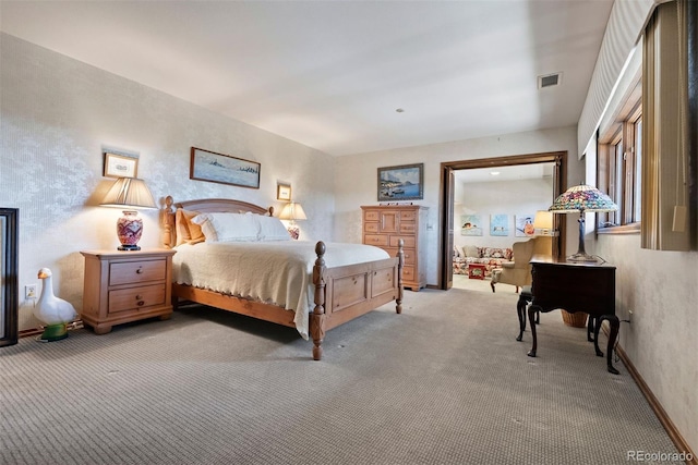 bedroom featuring light colored carpet, visible vents, and baseboards