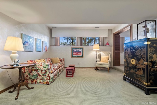 living room featuring carpet, visible vents, and baseboards