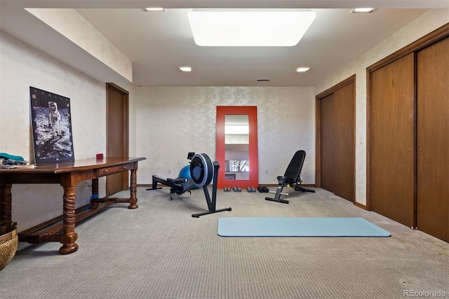 exercise area featuring carpet and a textured wall