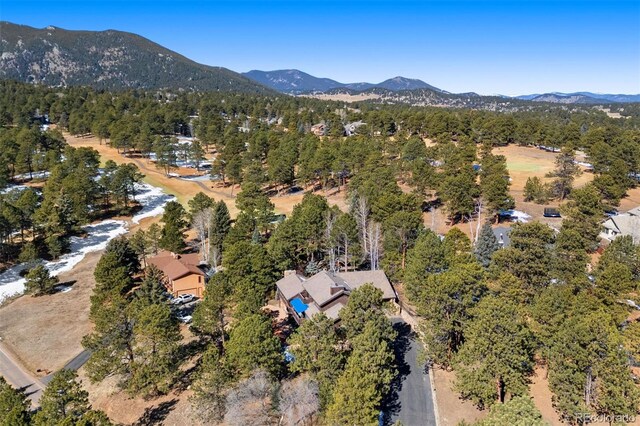 aerial view featuring a mountain view and a forest view