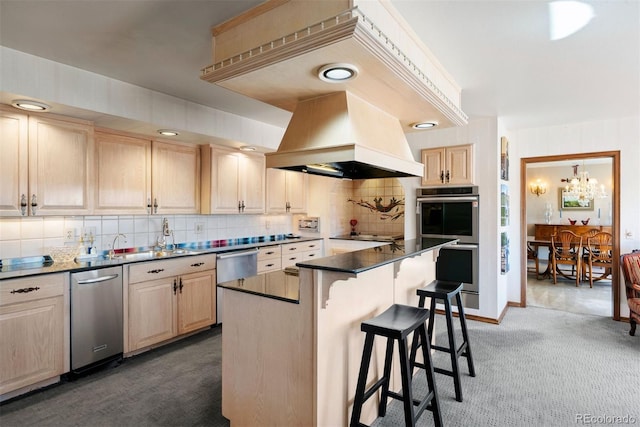 2851 Interlocken Dr, Evergreen, CO 80439 - kitchen with stainless steel appliances, custom range hood, light brown cabinetry, and carpet floors