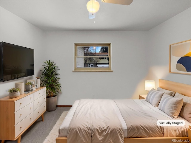 carpeted bedroom featuring baseboards and a ceiling fan