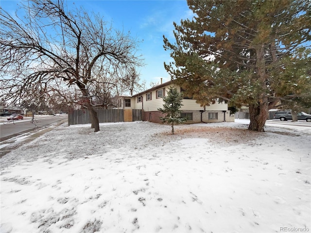 exterior space with brick siding and fence