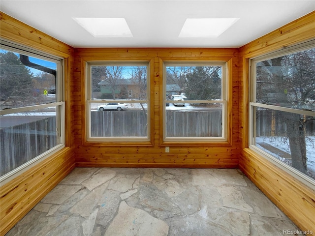 unfurnished sunroom featuring a skylight