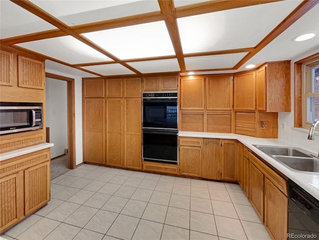 kitchen with light tile patterned flooring, light countertops, black appliances, a sink, and recessed lighting