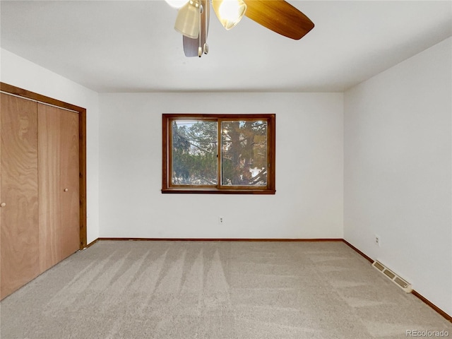 unfurnished bedroom featuring baseboards, visible vents, and carpet flooring