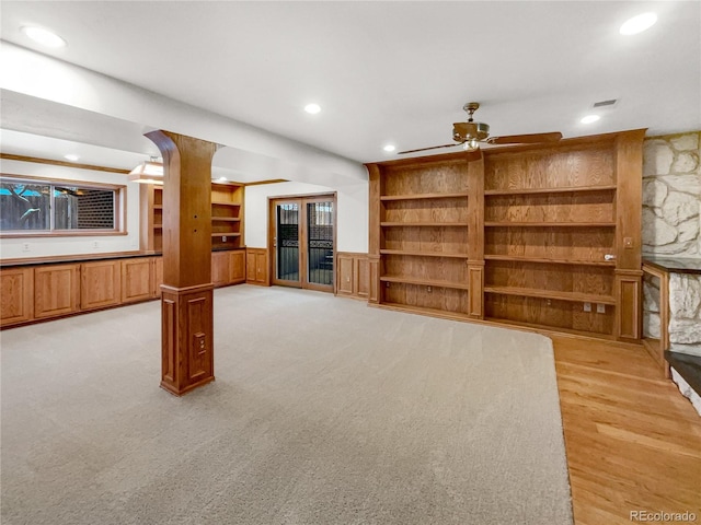 unfurnished living room featuring built in features, a wainscoted wall, recessed lighting, visible vents, and a ceiling fan