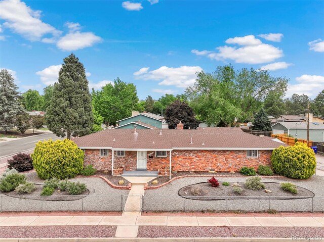 2043 Patrician Way, Colorado Springs, CO 80909 - single story home featuring a chimney and stone siding