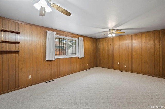 2043 Patrician Way, Colorado Springs, CO 80909 - carpeted empty room featuring ceiling fan and wooden walls
