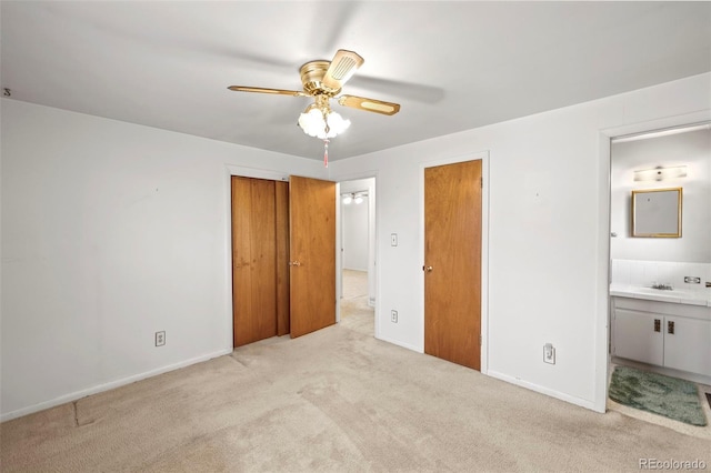 2043 Patrician Way, Colorado Springs, CO 80909 - unfurnished bedroom with light carpet, ensuite bath, baseboards, two closets, and ceiling fan