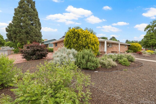 2043 Patrician Way, Colorado Springs, CO 80909 - view of side of home with brick siding