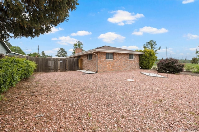 2043 Patrician Way, Colorado Springs, CO 80909 - rear view of property with brick siding and a chimney