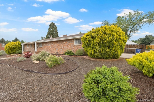 2043 Patrician Way, Colorado Springs, CO 80909 - view of property exterior with brick siding and a chimney