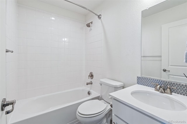 full bathroom featuring tiled shower / bath combo, vanity, and toilet