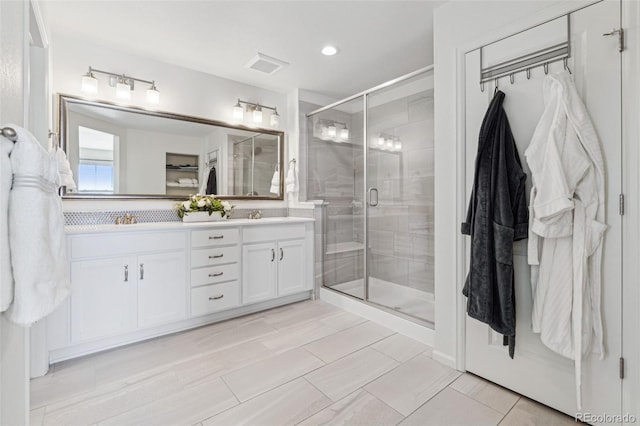 bathroom with vanity and walk in shower