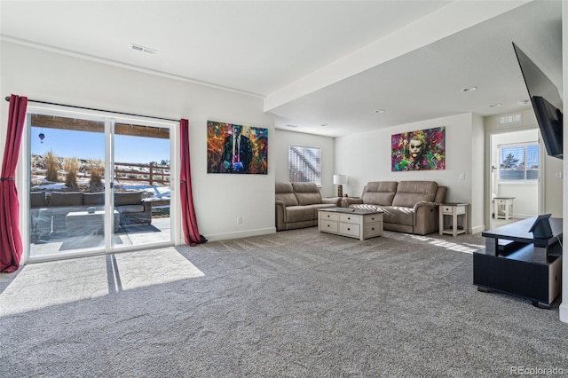 living room with a healthy amount of sunlight and light colored carpet