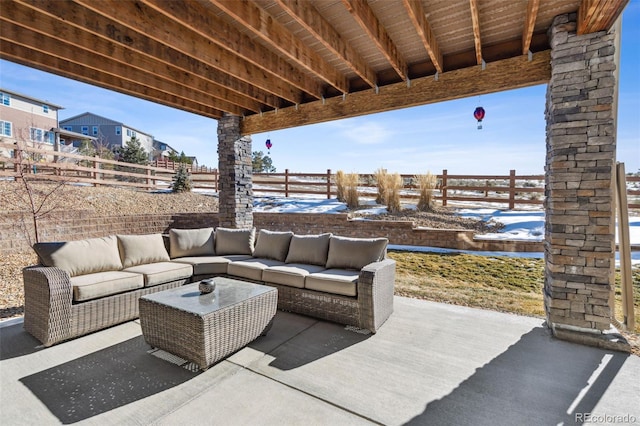 snow covered patio with an outdoor hangout area