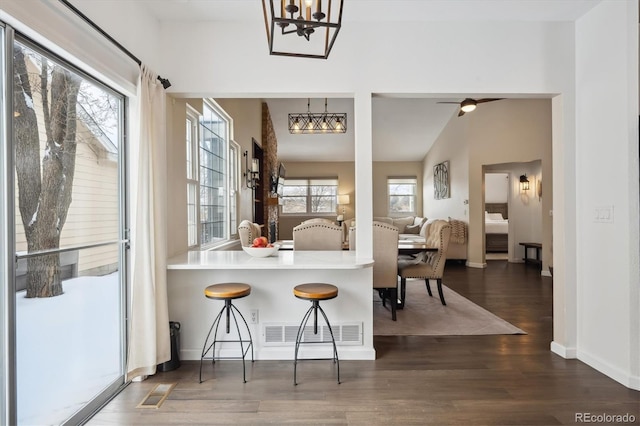 dining space with dark hardwood / wood-style floors and ceiling fan