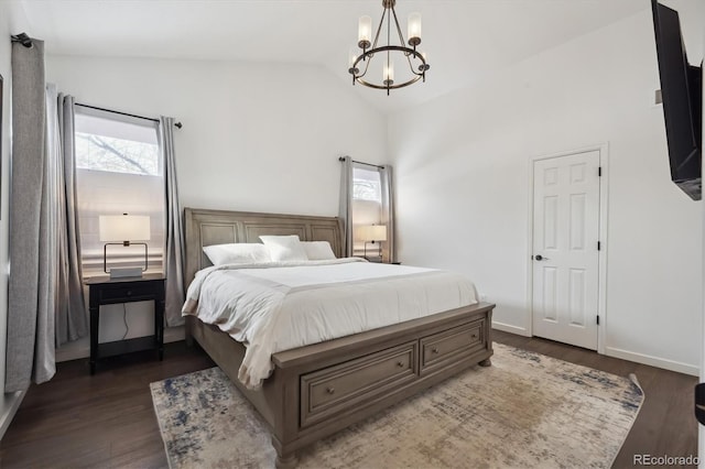 bedroom featuring dark hardwood / wood-style flooring, an inviting chandelier, and lofted ceiling