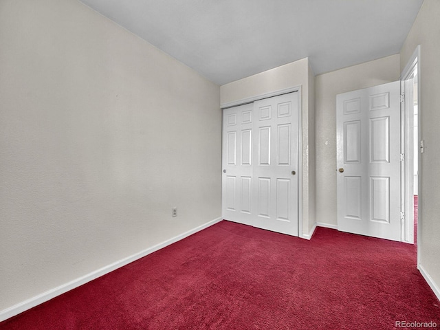 778 S Fairplay Ct, Aurora, CO 80012 - unfurnished bedroom featuring dark colored carpet, baseboards, and a closet