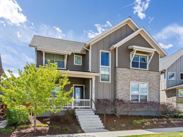 9378 E 60th Pl, Denver, CO 80238 - craftsman house featuring board and batten siding, a porch, a shingled roof, and stone siding