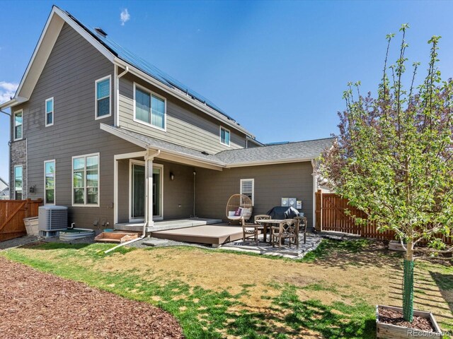9378 E 60th Pl, Denver, CO 80238 - rear view of house featuring a lawn, a gate, central air condition unit, a fenced backyard, and a patio