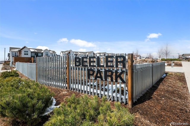 view of gate with fence and a residential view