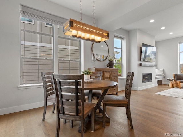 9378 E 60th Pl, Denver, CO 80238 - dining area with wood-type flooring, recessed lighting, baseboards, and a glass covered fireplace