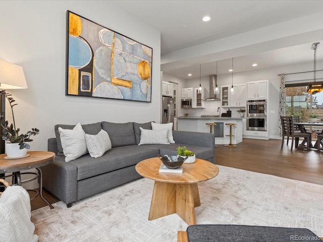 9378 E 60th Pl, Denver, CO 80238 - living area featuring recessed lighting, wood finished floors, and a notable chandelier