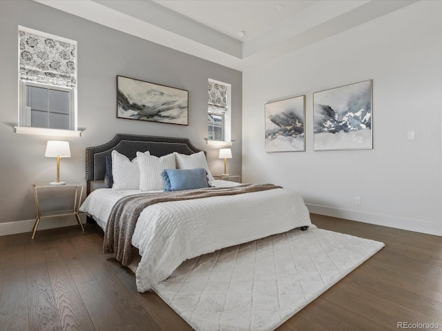 9378 E 60th Pl, Denver, CO 80238 - bedroom with wood-type flooring, baseboards, and a raised ceiling