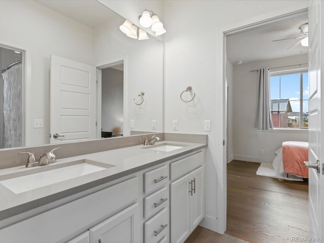 9378 E 60th Pl, Denver, CO 80238 - ensuite bathroom featuring ensuite bathroom, a sink, wood finished floors, and double vanity