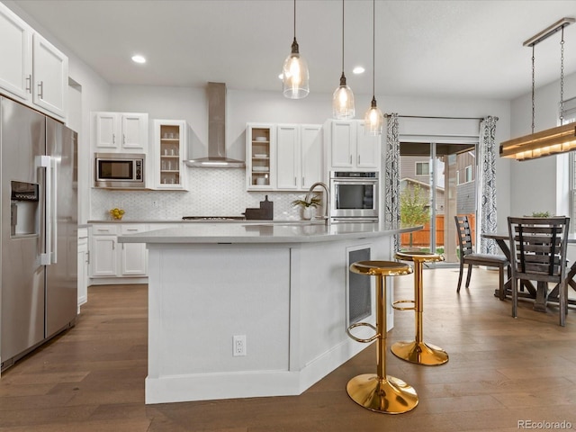 9378 E 60th Pl, Denver, CO 80238 - kitchen with wall chimney range hood, dark wood-type flooring, light countertops, white cabinetry, and stainless steel appliances