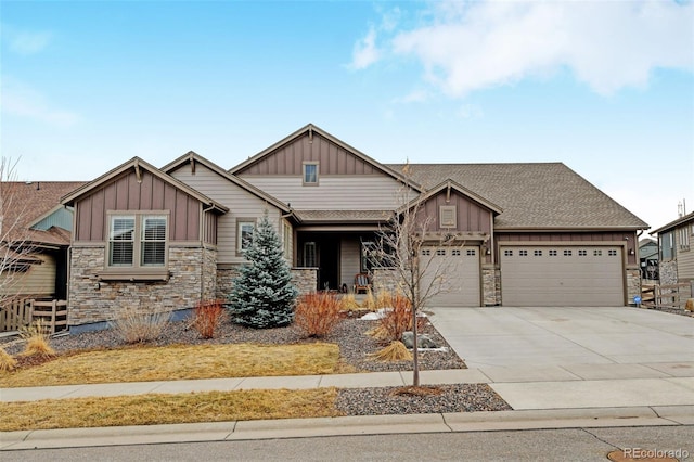 craftsman-style house featuring board and batten siding, stone siding, driveway, and a garage