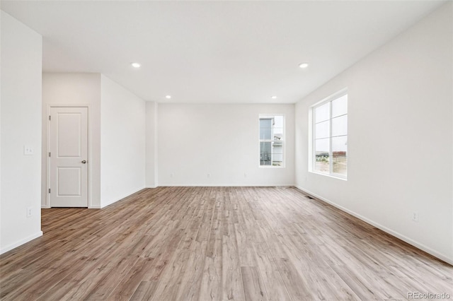 unfurnished room with light wood-type flooring