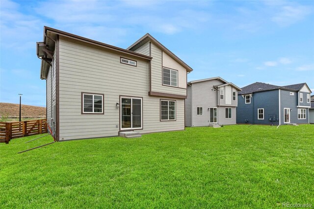 rear view of house with a yard