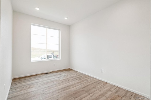 unfurnished room featuring light hardwood / wood-style floors and a healthy amount of sunlight