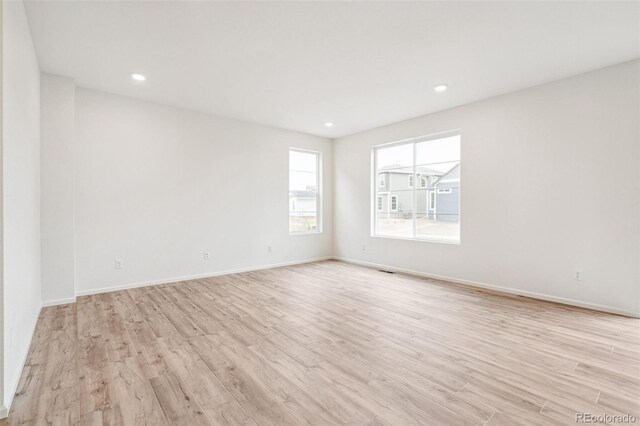 unfurnished room with light wood-type flooring