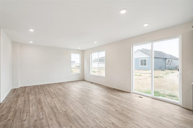 unfurnished room with light hardwood / wood-style floors