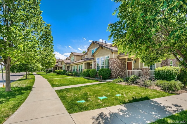 1067 Uinta Way Unit 1067, Denver, CO 80230 - view of front of property with brick siding and a front lawn