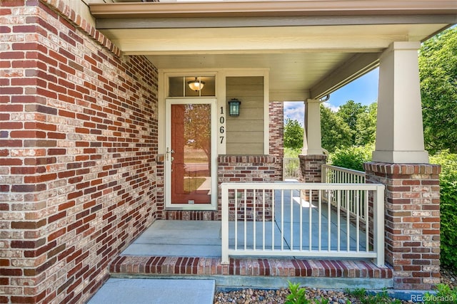 1067 Uinta Way Unit 1067, Denver, CO 80230 - property entrance with covered porch and brick siding