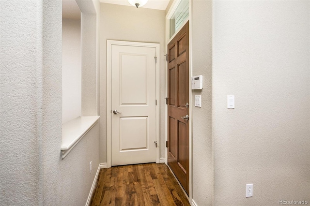 1067 Uinta Way Unit 1067, Denver, CO 80230 - hall featuring dark wood finished floors and a textured wall